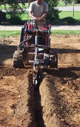 a Renton Sprinkler Installation tech trenching a line for a new system 